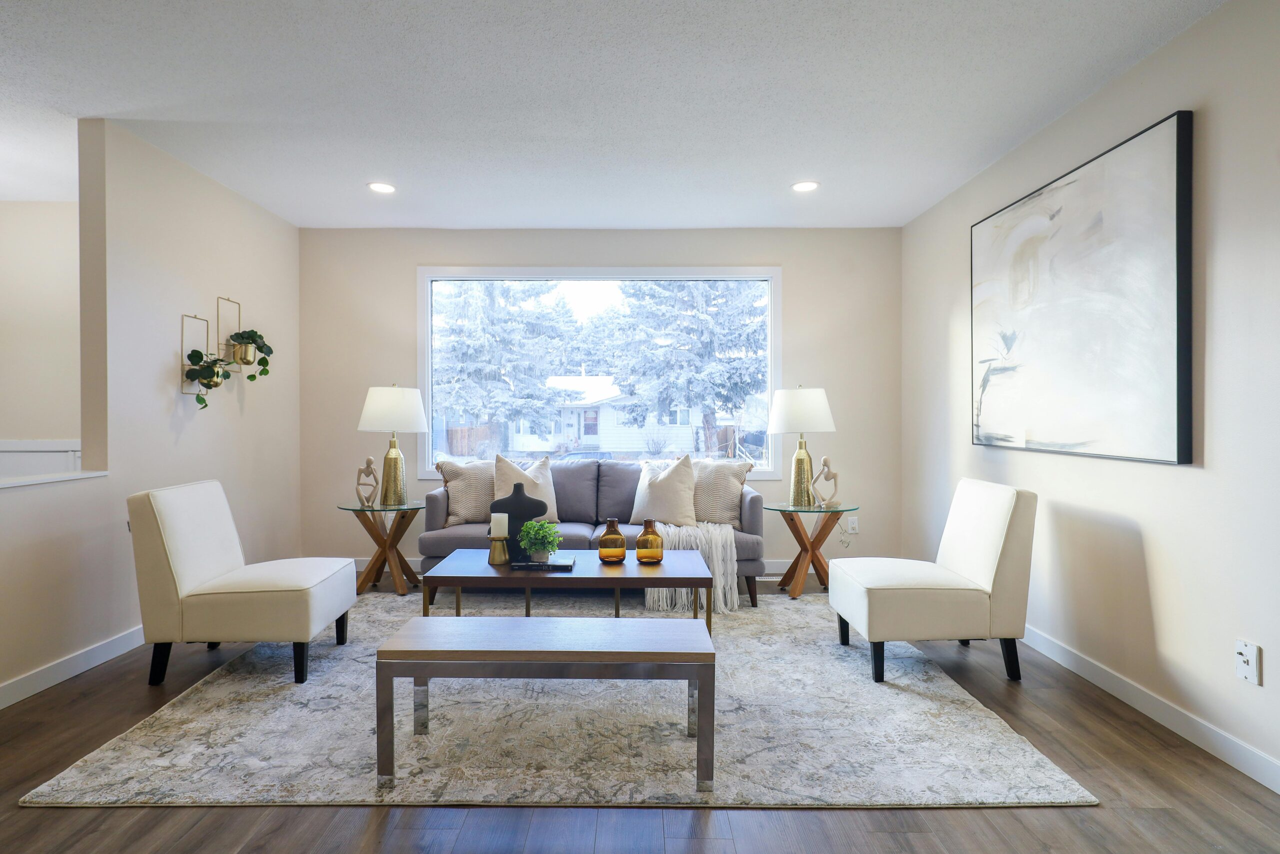 Stylish living room featuring chic furniture and a snowy window view in Edmonton.